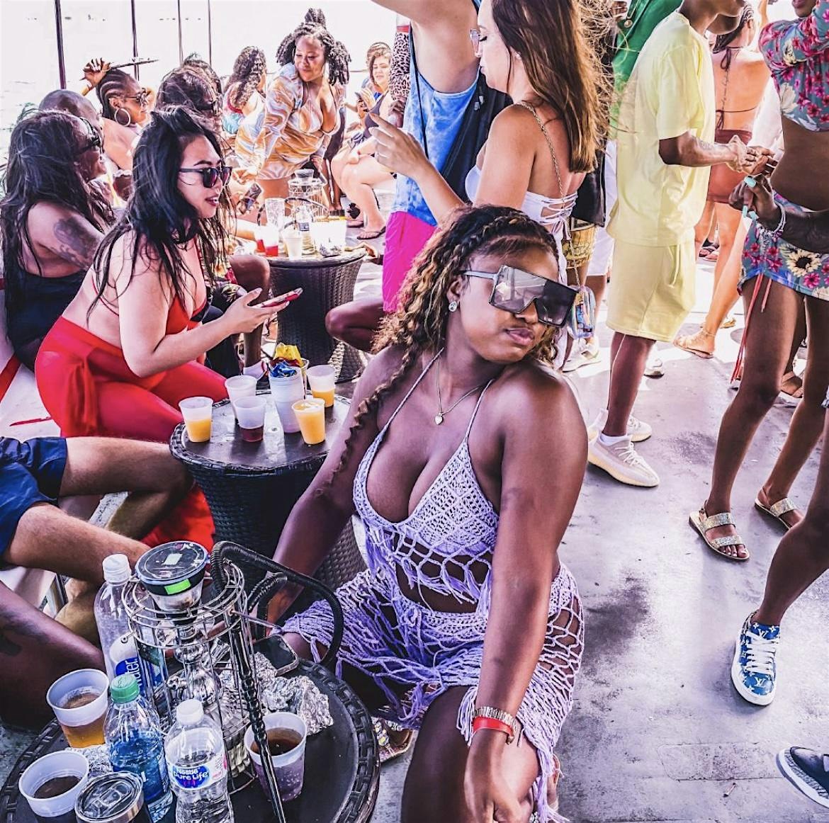 Crowd vibing on the boat with drinks